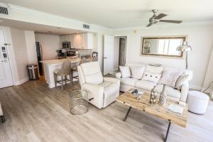 a living room with a couch and a table at Lovers Key Resort 404 in Fort Myers Beach