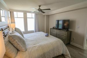 a bedroom with a bed and a flat screen tv at Lovers Key Resort 404 in Fort Myers Beach