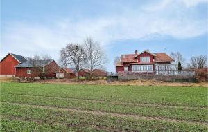 a large red house with a field in front of it at 5 Bedroom Pet Friendly Home In Sollebrunn in Sollebrunn