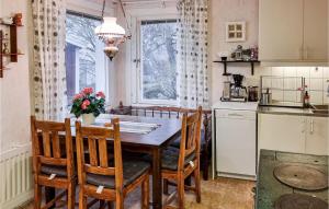 a kitchen with a table and chairs and a window at Stunning Home In Bullaren With 1 Bedrooms in Bullaren