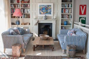 a living room with two chairs and a fireplace at St Mawes Hotel in Saint Mawes