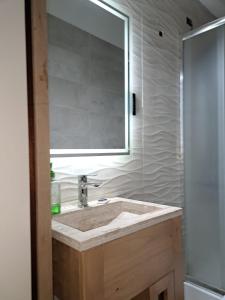 a bathroom with a sink and a mirror at La Marta in Ciudad Lujan de Cuyo