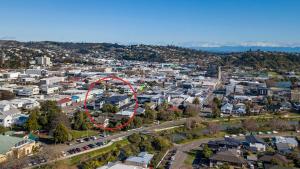 an aerial view of a city with a red circle at Malthouse Lane City Apartment 3 in Nelson