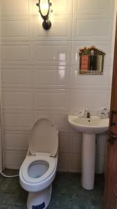 a bathroom with a toilet and a sink at Pakse Backpacker Hostel2023 in Pakse