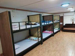 a group of bunk beds in a room at Pakse Backpacker Hostel2023 in Pakse