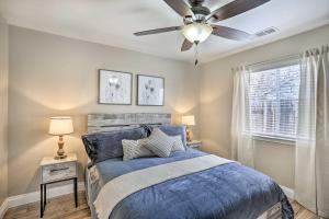 a bedroom with a blue bed with a ceiling fan at Charming Redding Home with Furnished Patio! in Redding