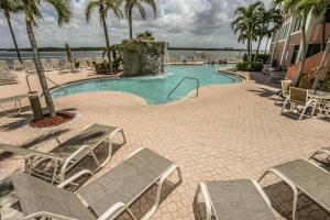 a swimming pool with lounge chairs and a swimming pool at Lovers Key Resort Penthouse 3 in Fort Myers Beach