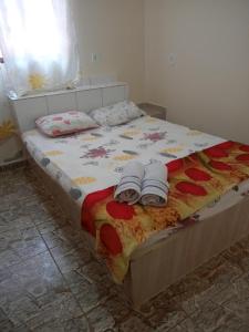 a bedroom with a bed with two towels on it at ApartHotel Família Meireles in Luziânia