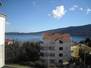 a building with a view of a body of water at Apartment Sretno Good Luck in Herceg-Novi