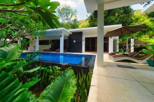 a swimming pool in the backyard of a house at Villa Collard in Senggigi 