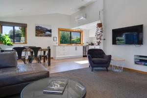 a living room with a couch and a table at Remarkable View 4 Bedroom in Queenstown