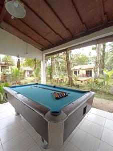 a pool table sitting on top of a patio at Kambuna Bungalow in Krui