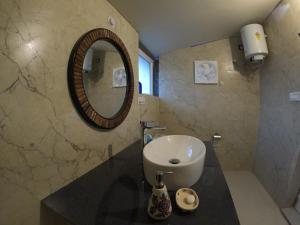 a bathroom with a sink and a mirror at The Soul Stroll Cottages Retreat in Mukteswar +86 photos