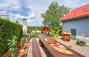 a backyard with a wooden table with food on it at Lovely Home In Beletinec With Wifi in Beretinec