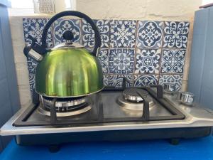 a green tea kettle sitting on top of a stove at Agulhasbestview in Agulhas