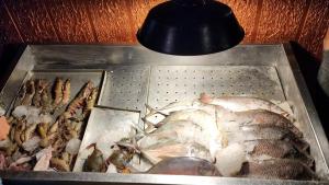 a tray of food with fish and a light at SkyLounge Residency in Trivandrum