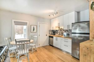 a kitchen with a table and chairs and a refrigerator at Anchorage Home, Minutes From Downtown! in Anchorage