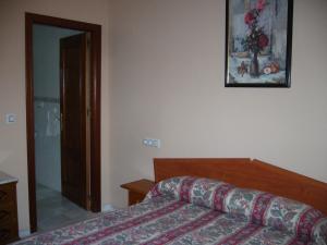 A bed or beds in a room at Apartamentos Alamare