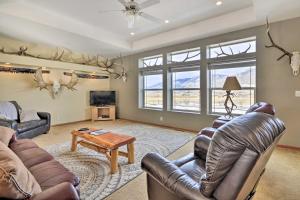 a living room with couches and a table at Charming Cody Vacation Home with Mtn Views! in Cody