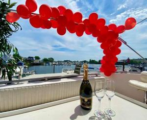 a bottle of champagne and two glasses on a balcony at Romantic Condo @ Ocean 3-deck Yacht in Brooklyn