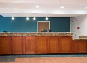 an empty lobby with a desk in a building at MY HOME & SUITES MADISON GA in Madison