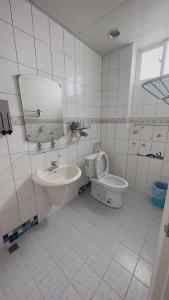 a white bathroom with a sink and a toilet at Swallow homestay in Taitung City