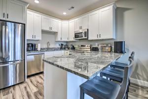 a kitchen with white cabinets and a granite counter top at Refreshing Tennessee Vacation Rental! in La Follette