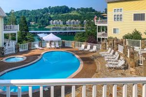 a swimming pool on the balcony of a house with a view of the water at Refreshing Tennessee Vacation Rental! in La Follette
