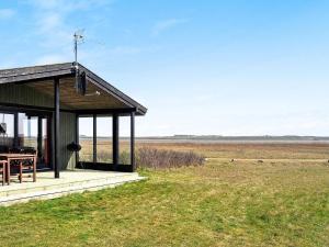 a pavilion with a table in a field at 5 person holiday home in Harbo re in Harboør