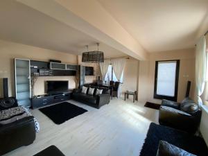 a living room with a couch and a table at Penthouse City Centre in Iaşi