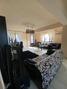 a bedroom with a bed and a living room at Penthouse City Centre in Iaşi