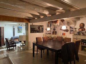 a kitchen and dining room with a table and chairs at LA VIEILLE FERME in Err