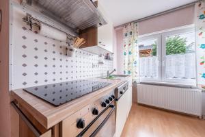 a kitchen with a stove and a window at Ferienhaus Hunsrückliebe in Liederbach