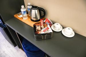 a table with a coffee pot and plates on it at Plus Hotel & Private Transportation İstanbul Airport-By Loft in Arnavutköy