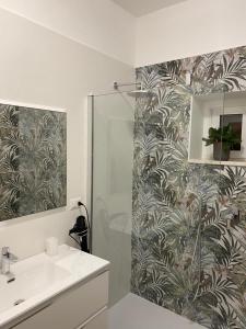 a bathroom with a shower with a sink and a mirror at M&G holiday house in Matera +61 photos