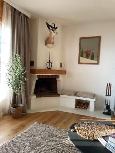 a living room with a fireplace with a deer head on the wall at Apartment with stunning view! Ski-in, ski-out in Villars-sur-Ollon