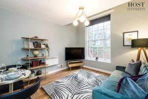 a living room with a couch and a tv at Host & Stay - Canning Quarters in Liverpool