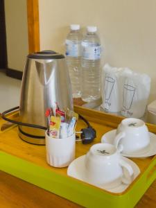 a tray with a tea kettle and cups on a table at Phangan Island View - SHA Extra Plus in Ban Tai