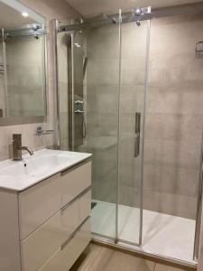 a bathroom with a shower and a sink at Modernes Apartment mit traumhaftem Blick Vistamar3 in Cala'n Porter