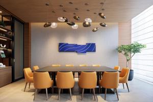 a dining room with a table and chairs at Sheraton Grand Hiroshima Hotel in Hiroshima