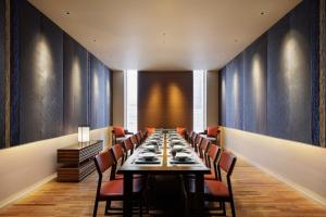 a long dining room with a long table and chairs at Sheraton Grand Hiroshima Hotel in Hiroshima