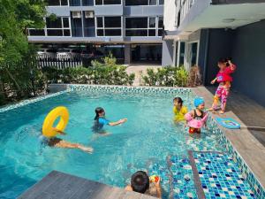 um grupo de crianças a brincar numa piscina em The Key Point Hotel em Bangkok