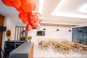 a dining room with a long table and balloons at Spotlight Hotel in Alaminos