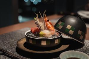 a plate of food on a table with a spoon at Sheraton Grand Hiroshima Hotel in Hiroshima