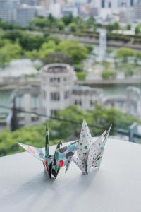 two origami birds sitting on top of a table at Sheraton Grand Hiroshima Hotel in Hiroshima