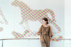 a woman standing in front of a painting of a horse at Sheraton Grand Hiroshima Hotel in Hiroshima