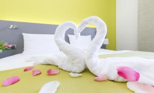 Posteľ alebo postele v izbe v ubytovaní Hotel Herrmes