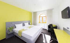 Posteľ alebo postele v izbe v ubytovaní Hotel Herrmes