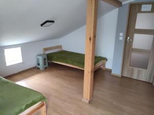 a bedroom with a bunk bed in a room at Apartamenty Dominik in Wiele