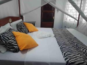 Postel nebo postele na pokoji v ubytování Cosy apartment in Malindi beach